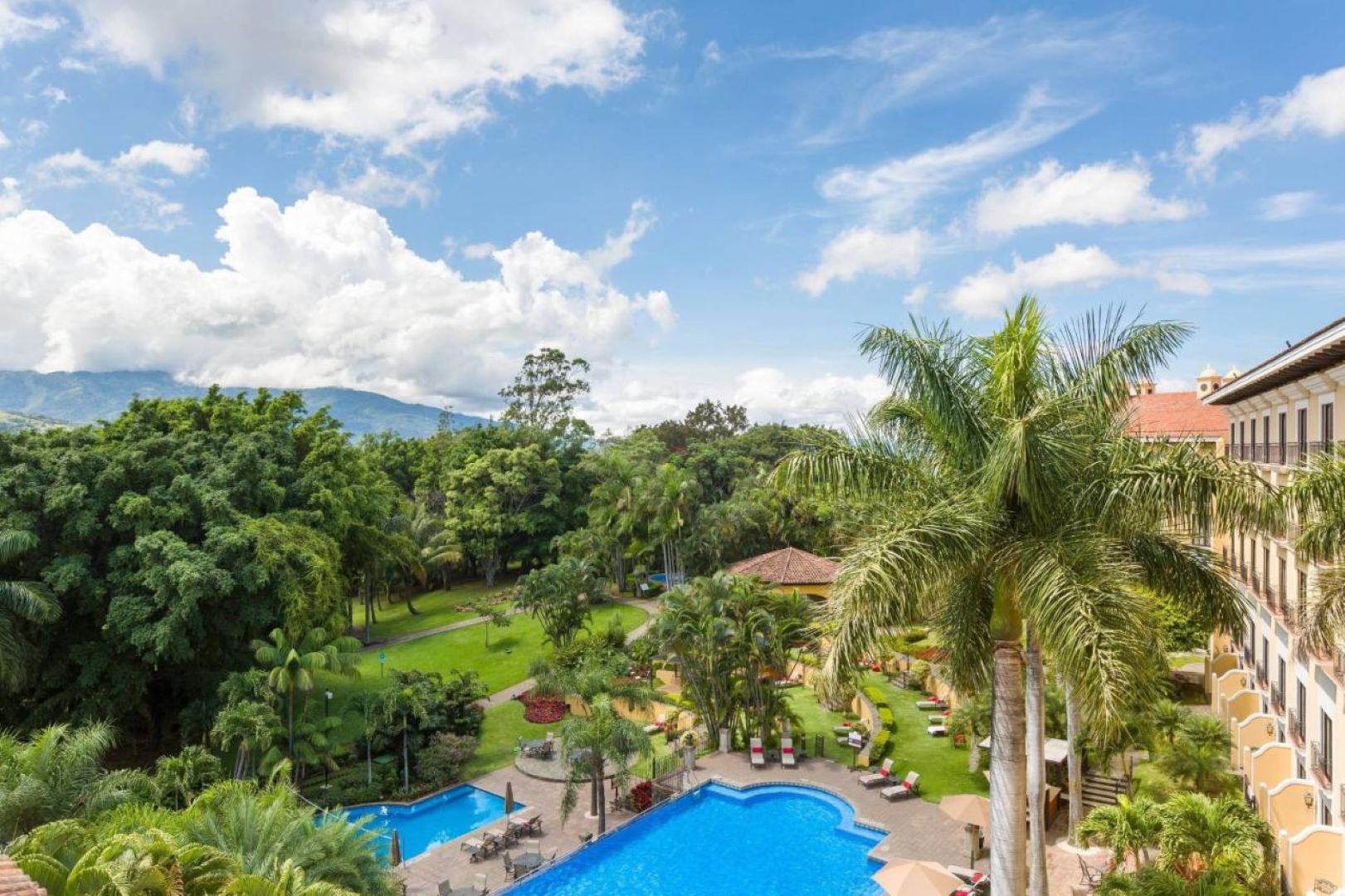 Luxury swimming pool at Costa Rica Marriott Hotel surrounded by tropical gardens.